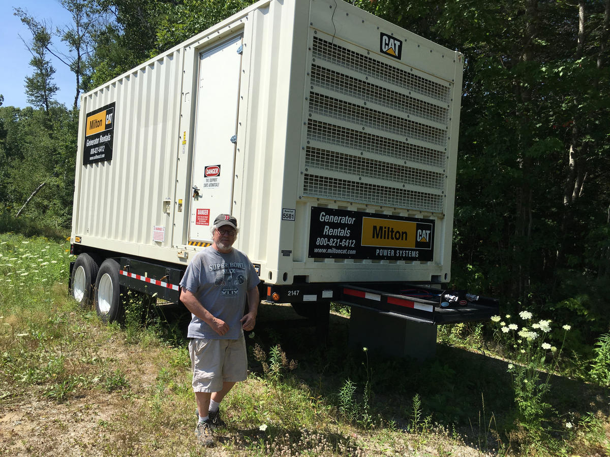 A grid-scale diesel generator near Mike Elkins' furniture-making company can quickly deliver 500 kilowatts of electricity to the Boothbay area. Credit: Fred Bever, MPBN