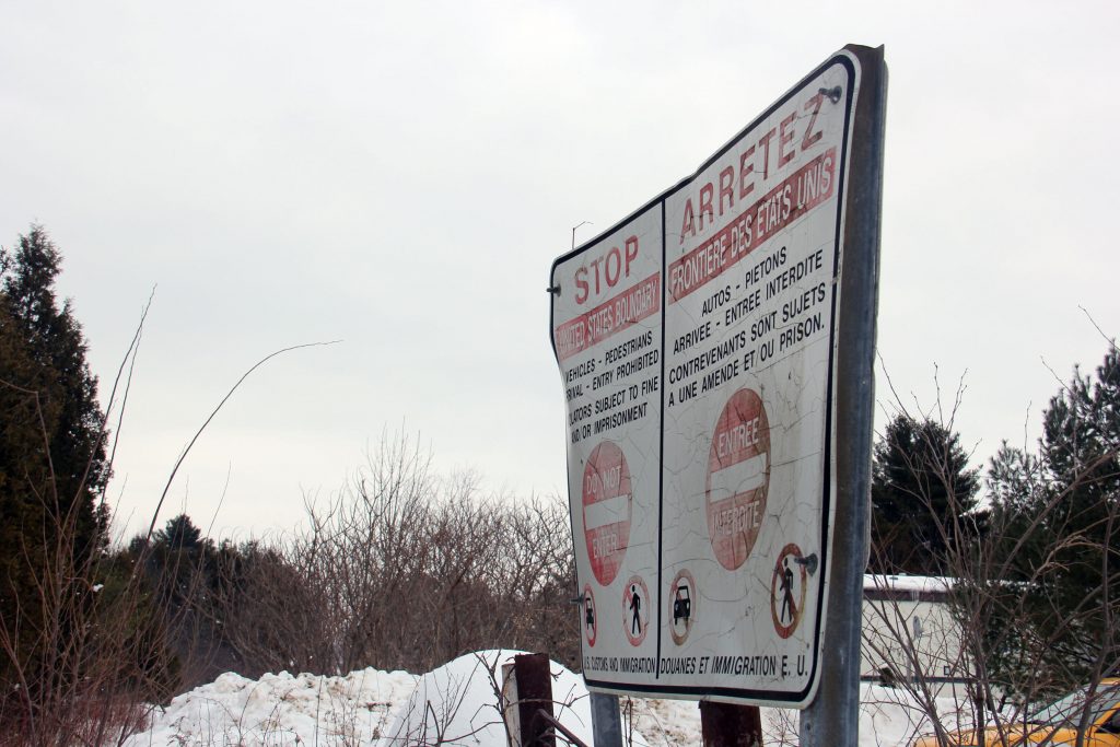 This sign marks the Canadian side of the border at one rural area where many people are crossing illegally into Canada. Mamadou was in the woods somewhere within 20 miles of here.
Photo by Kathleen Masterson for NENC