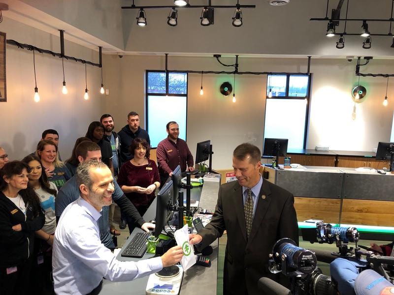 Northampton Mayor David Narkewicz makes the first purchase at NETA from co-owner Arnon Vered on Tuesday. Photo by Alden Bourne for NEPR