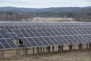Rows of solar panels, with mountains and trees in the background, are pictured on April 5, 2023, at the Keene wastewater treatment facility in Swanzey, N.H.