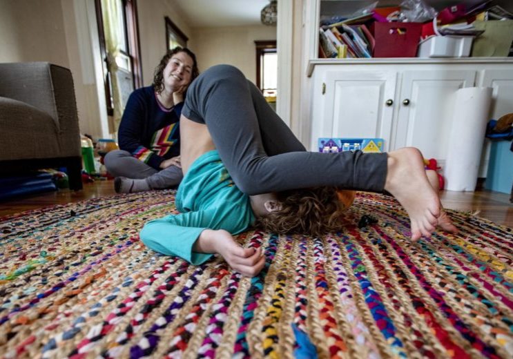 hallel02-wide Hallel with their mother in the family's living room. (Jesse Costa/WBUR)