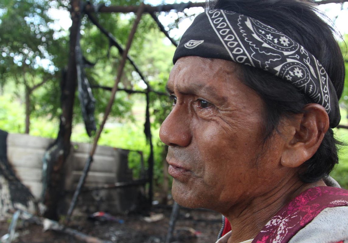 Rafael Morales stands in front of his home hours after he and neighbors allege Nicaraguan police burned it down. The motive for the attack is unclear as Morales said he is a Sandinista government supporter. Photo by Lorne Matalon for VPR